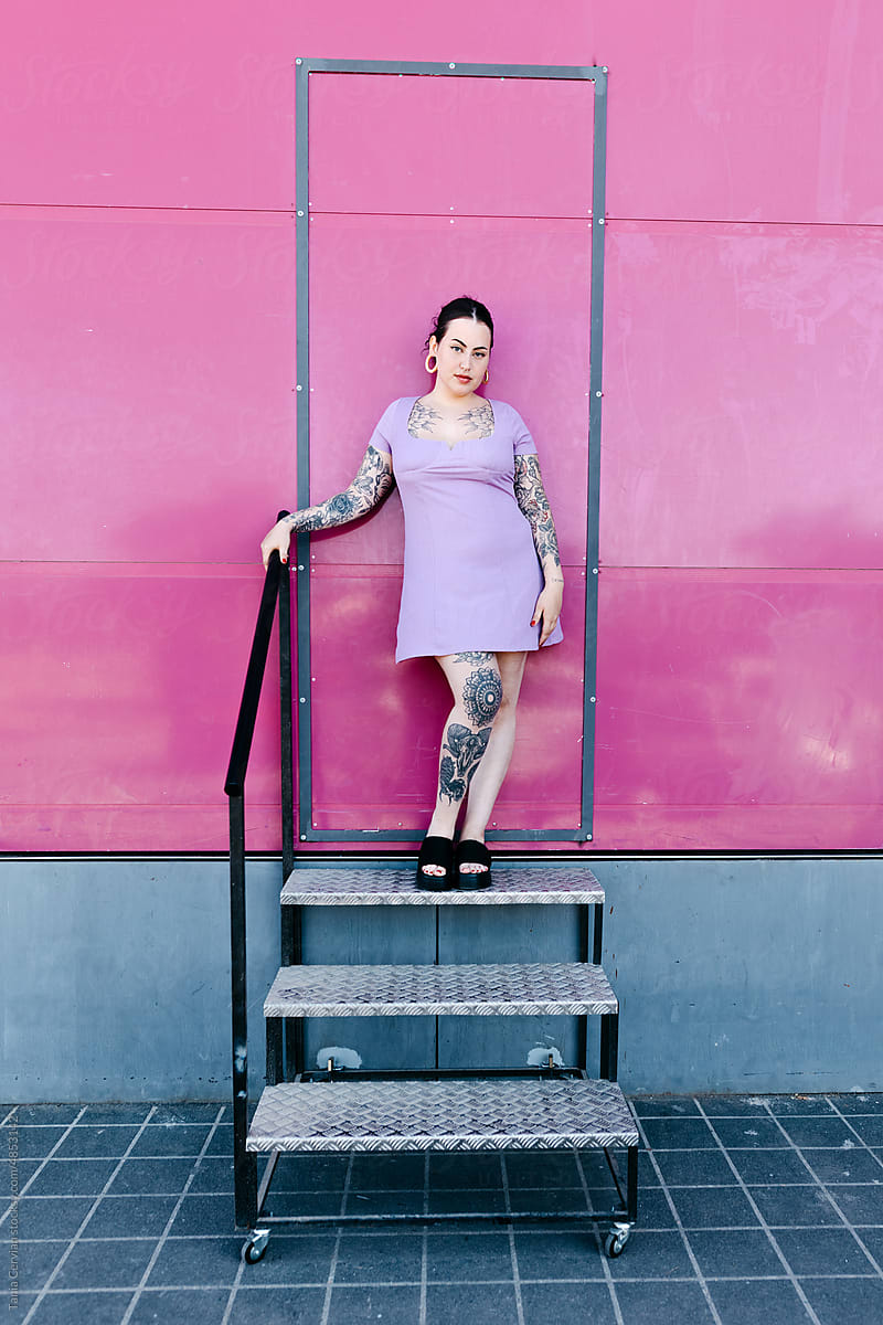 Tattooed woman standing on steps