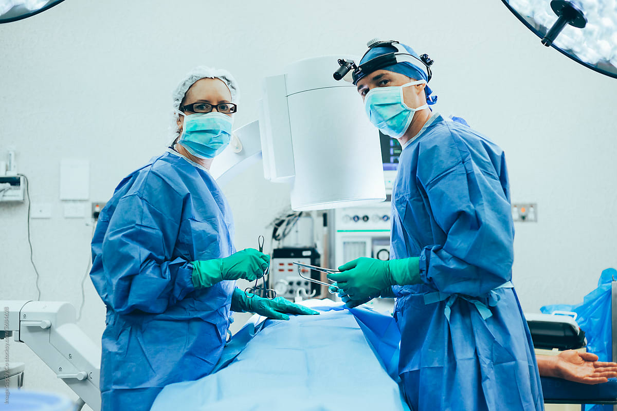 Surgeon and nurse in operating theater