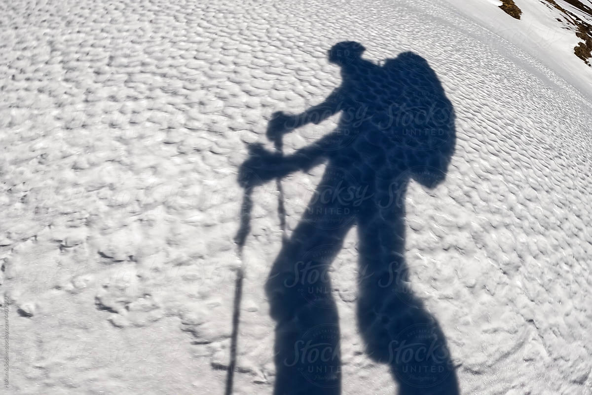 shadow of man walking on snow
