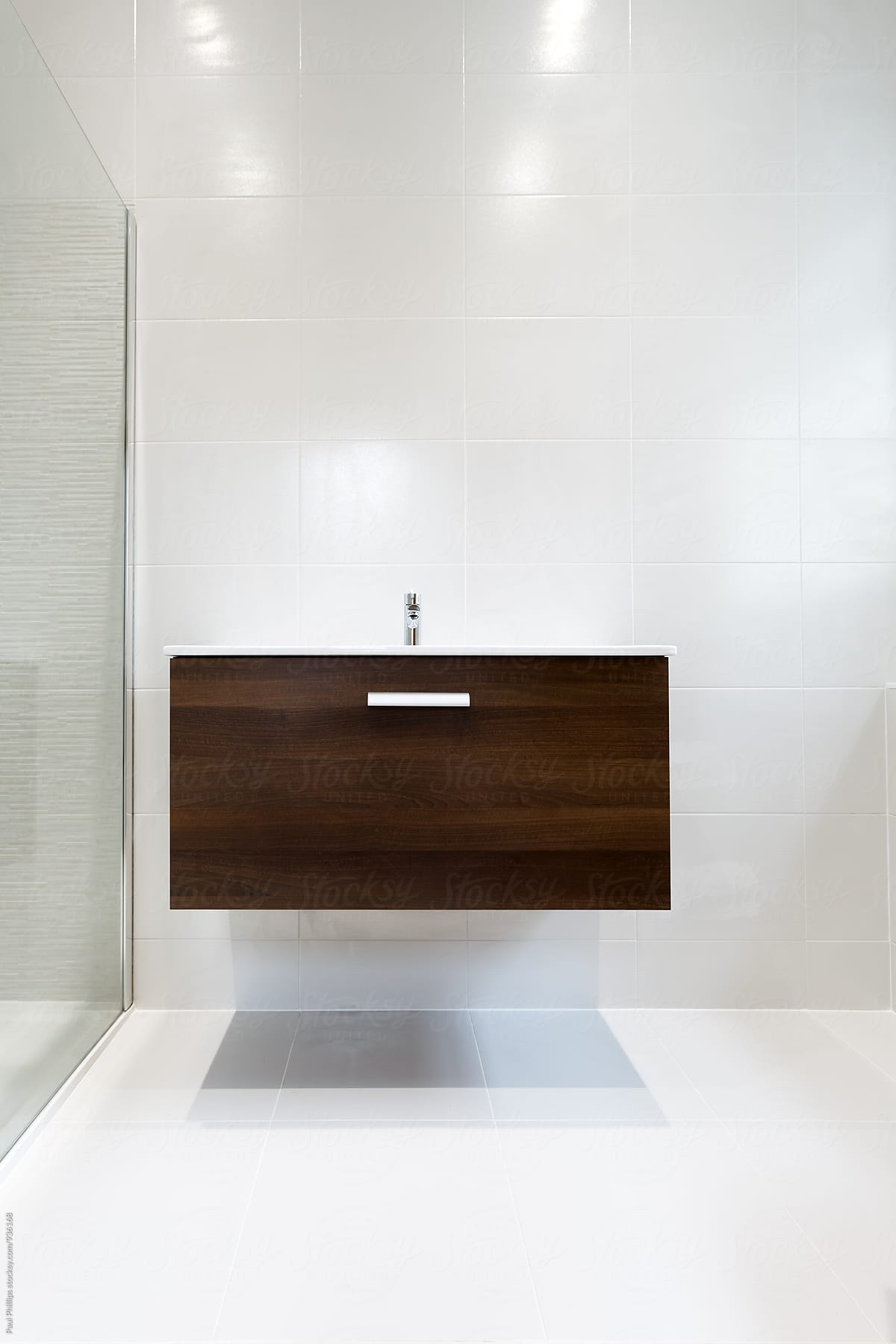 Wall hung vanity unit with sink in a contemporary shower room.