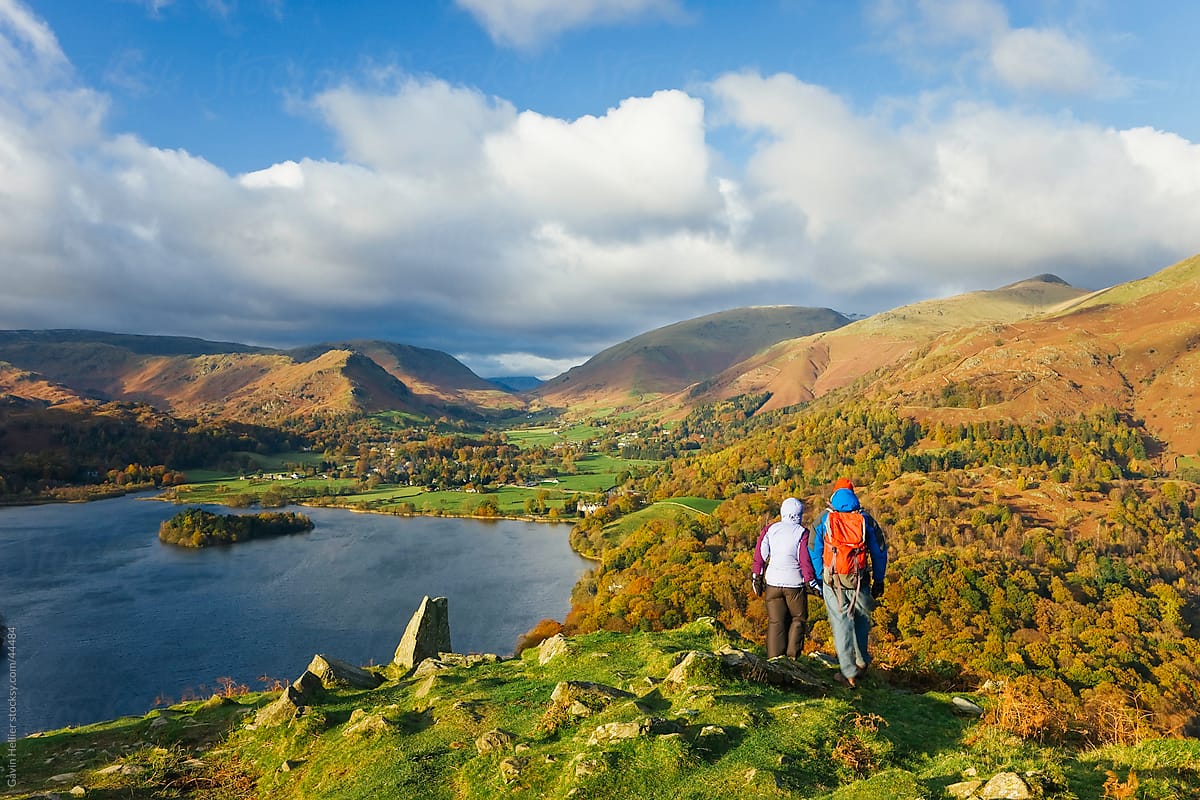 Walkers viewing Grasmere lake and village from Loughrigg Fell, Lake District National Park, Cumbria, UK
