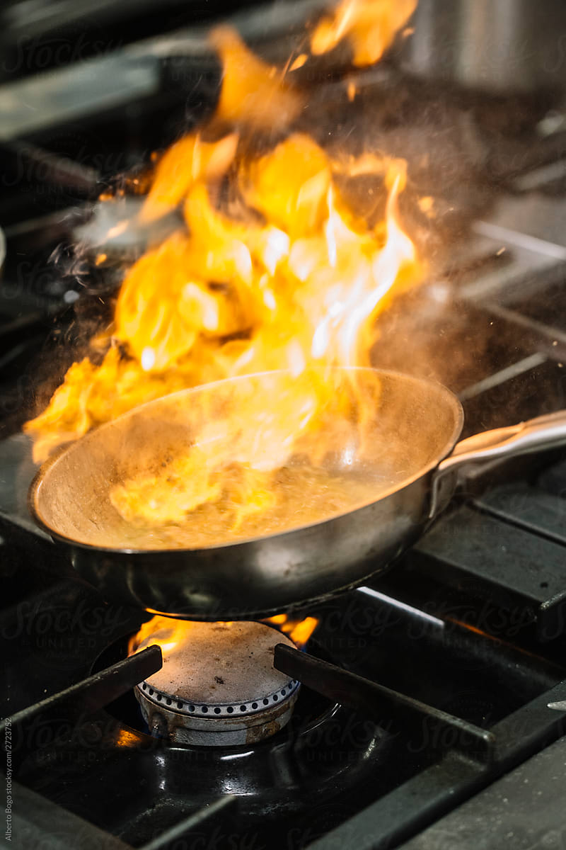 Frying pan with fire over stove