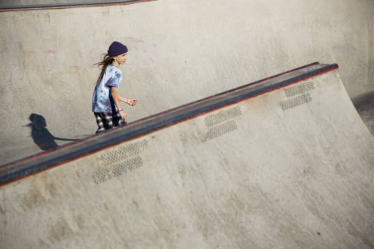 Teen skater riding skateboard in bowl