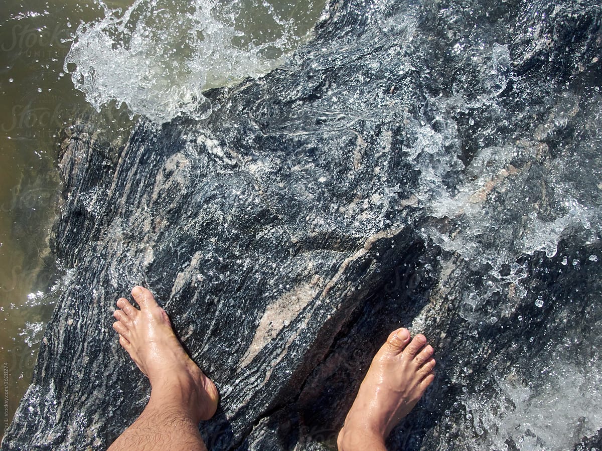 Standing on the foot of the rock at the seaside, closeup