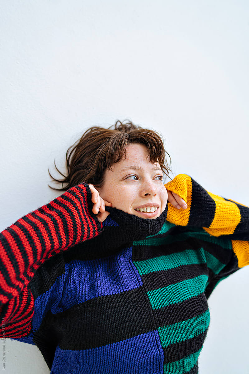 portrait of a cheerful girl in a colored sweater