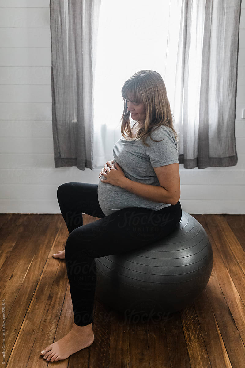 full term pregnant woman on exercise ball