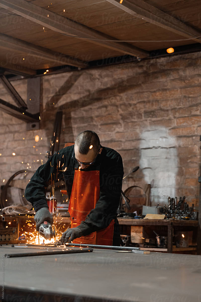 Professional metal worker sawing details