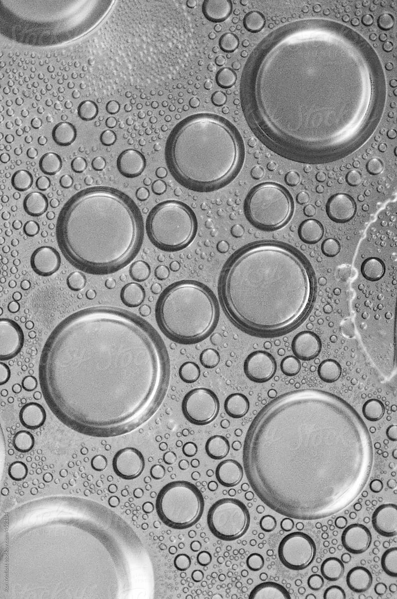 closeup macro black white bubbles intermixing water and oil