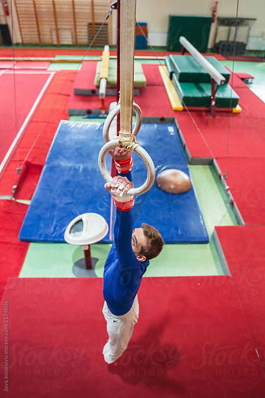 Male gymnast performing on gymnastic rings