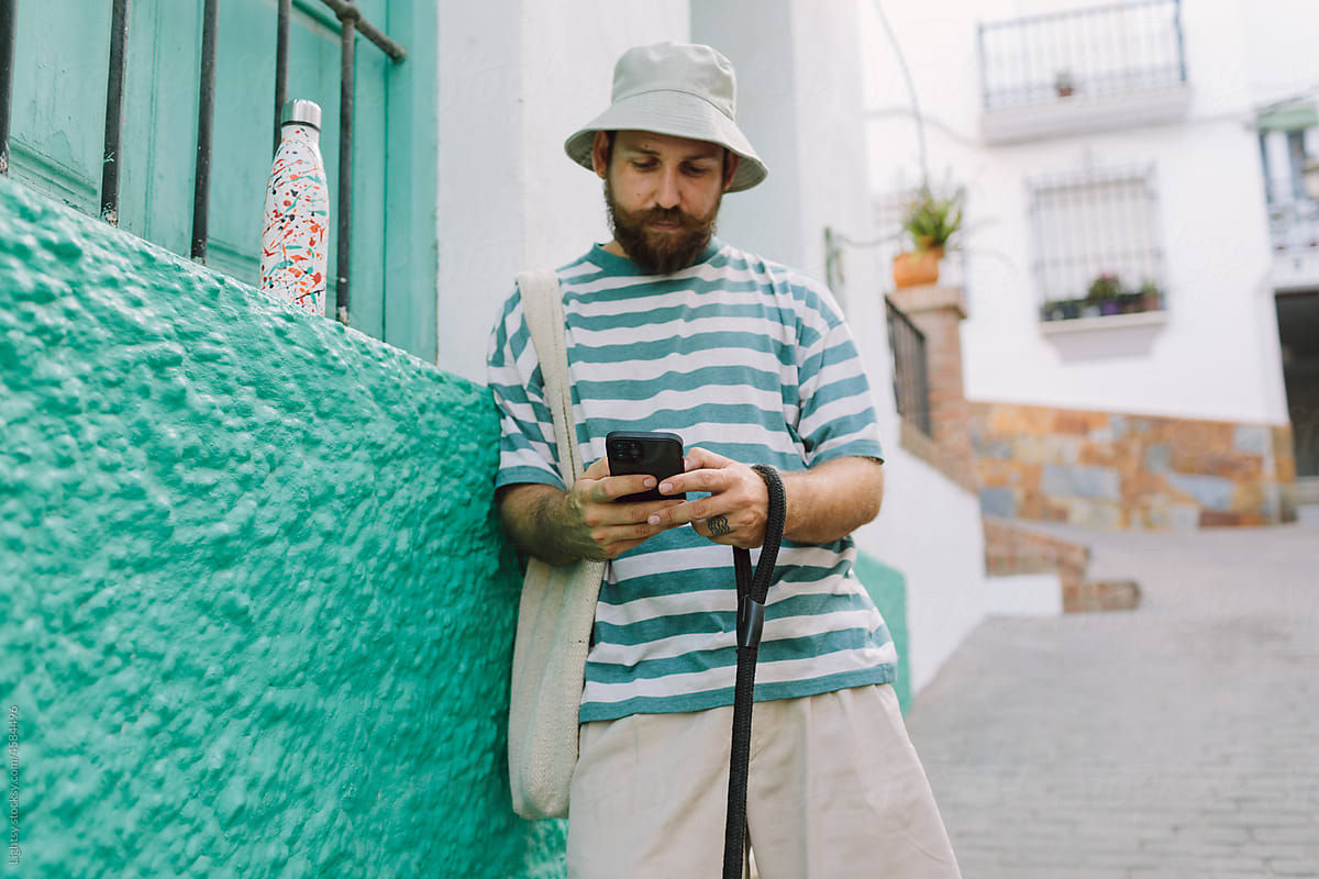 Man using a cell phone in a colorful street