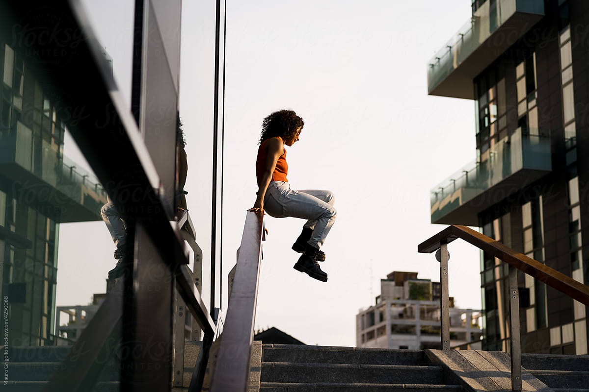 A woman jumping from a handrail