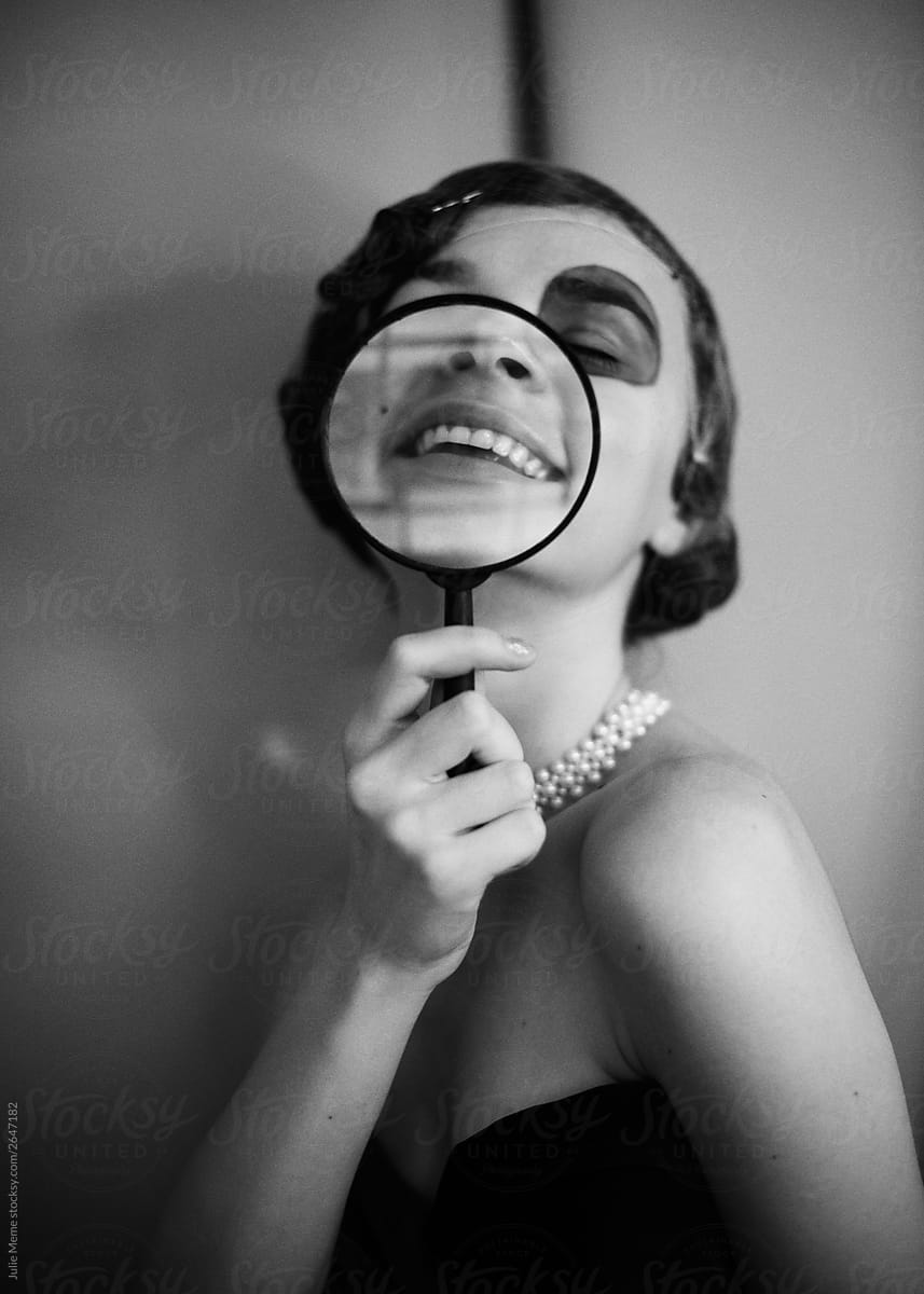 Smiling girl with magnifier