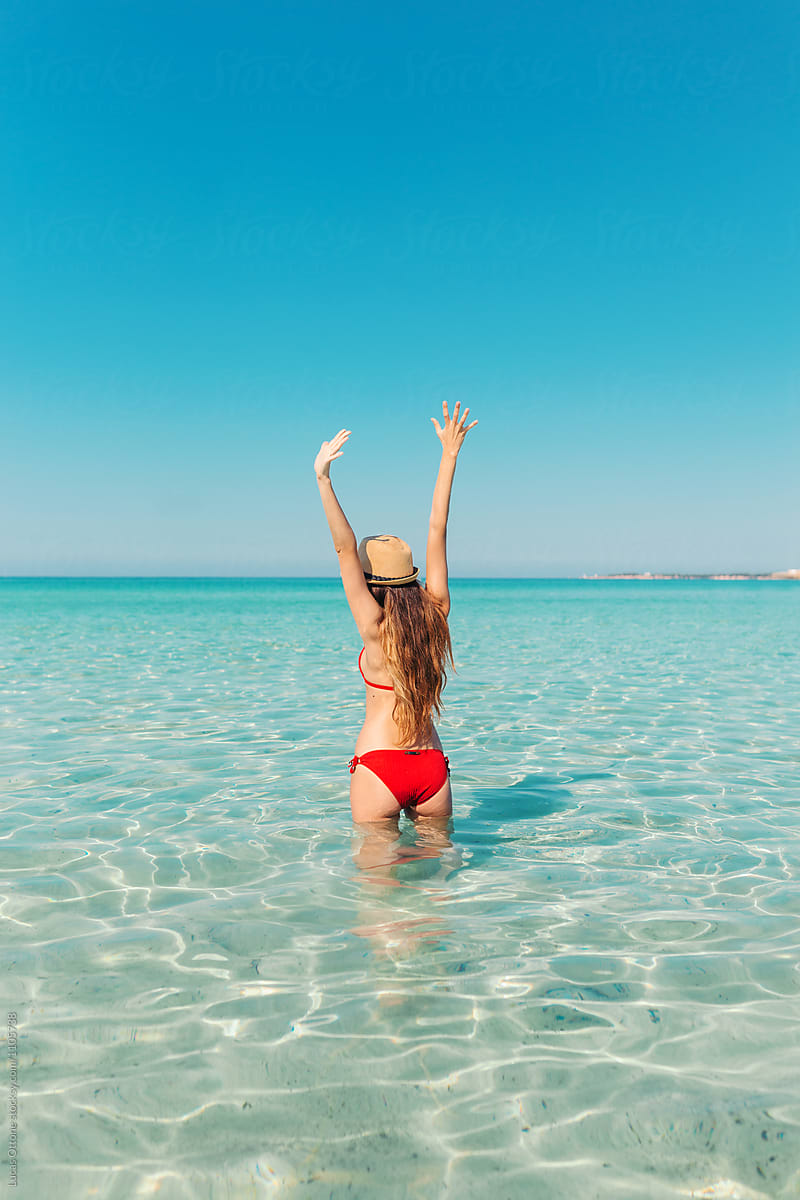 Happy young woman on a paradisiac beach