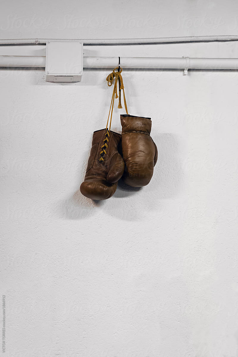 Vintage gloves hanging on white wall