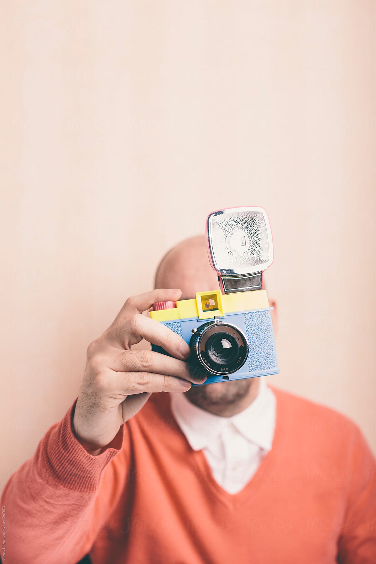 photographer holding toy plastic camera