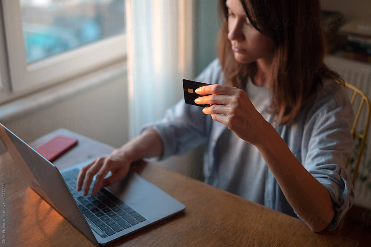 Woman working on laptop from home online payment