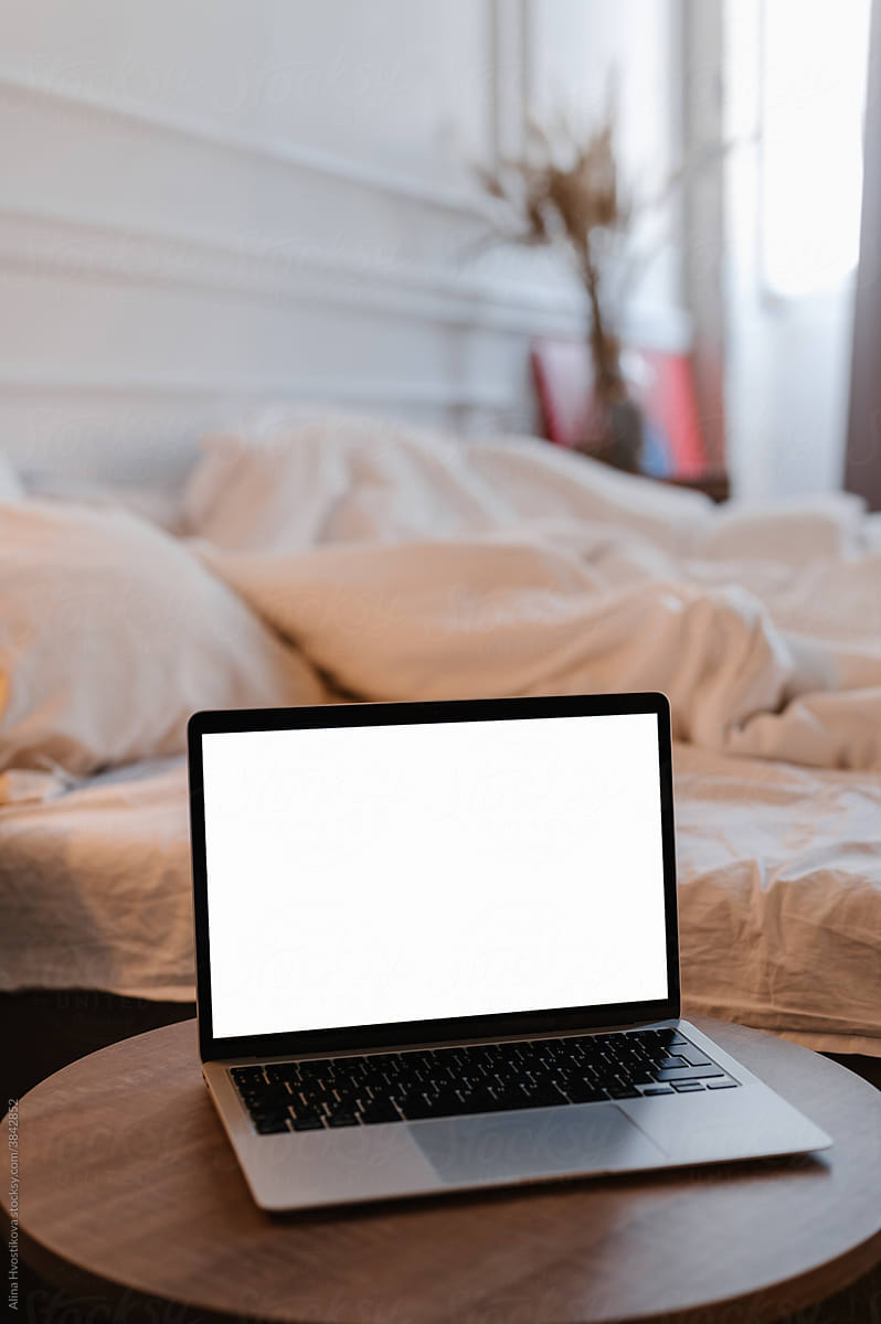 Laptop with empty screen in bedroom