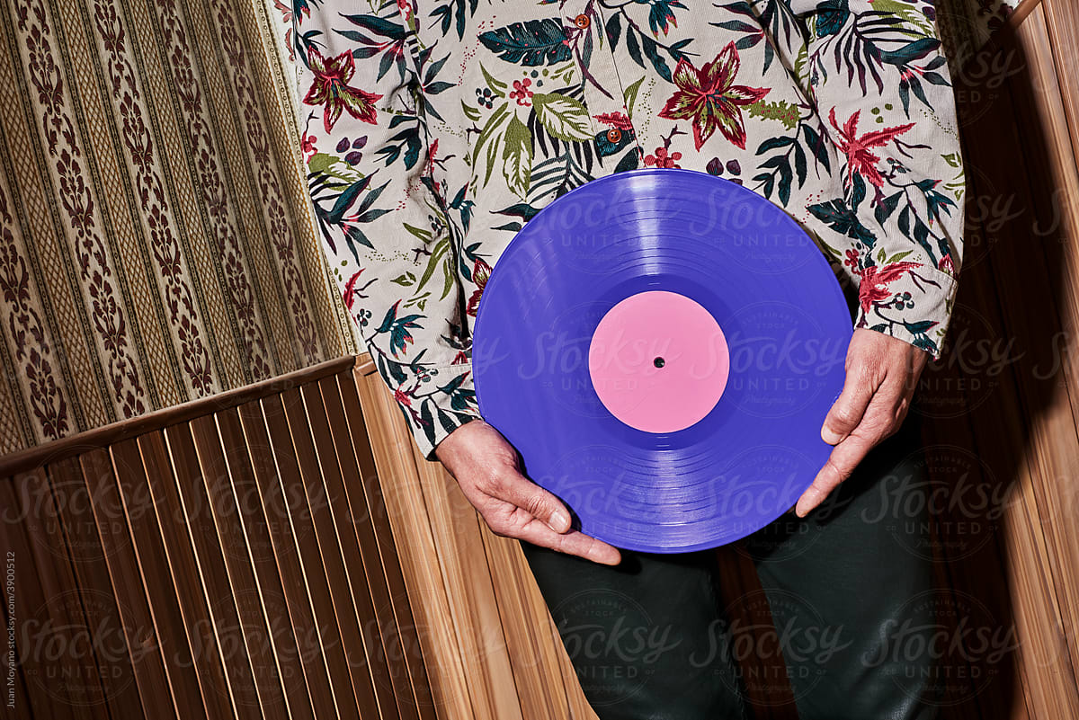 man holding a violet disc in front of him