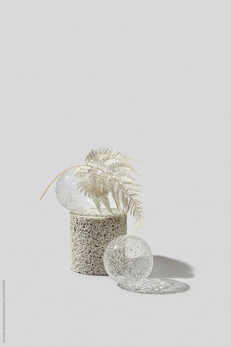 Crystal sphere ornaments with white plant leaf.