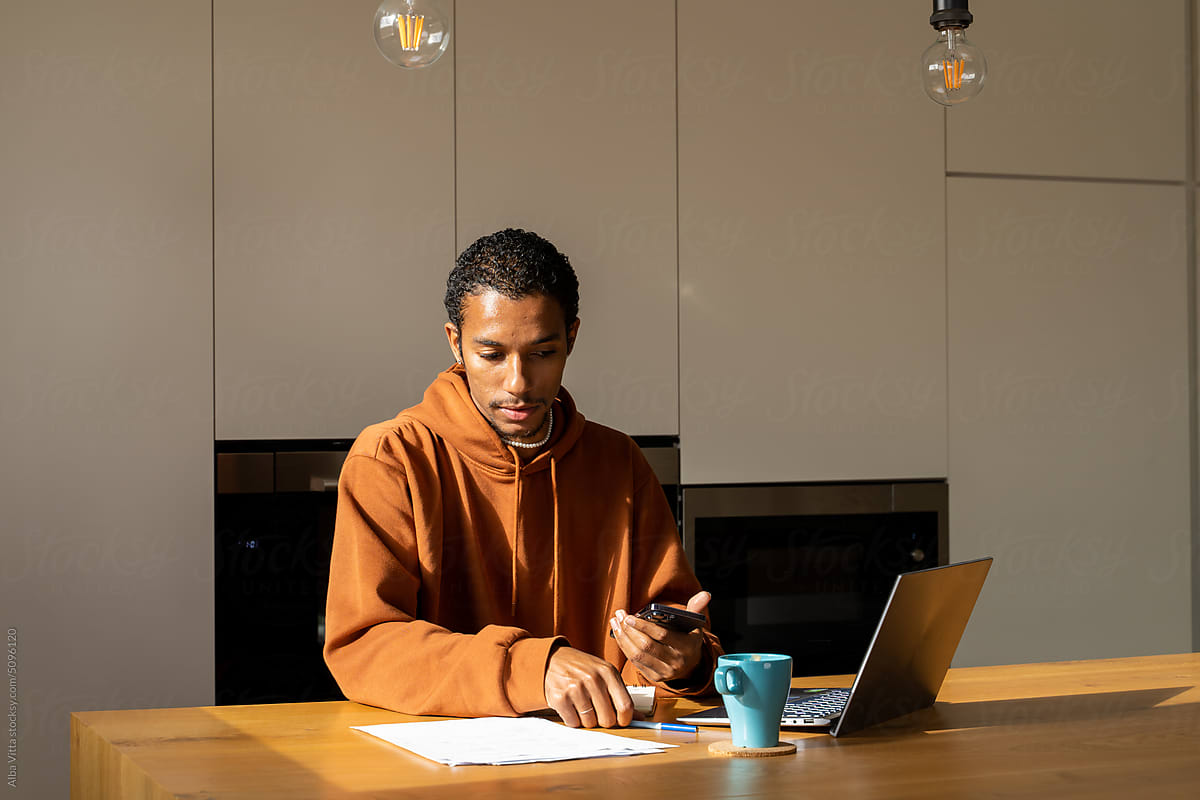 Man paying utility bills from home calculating expenses