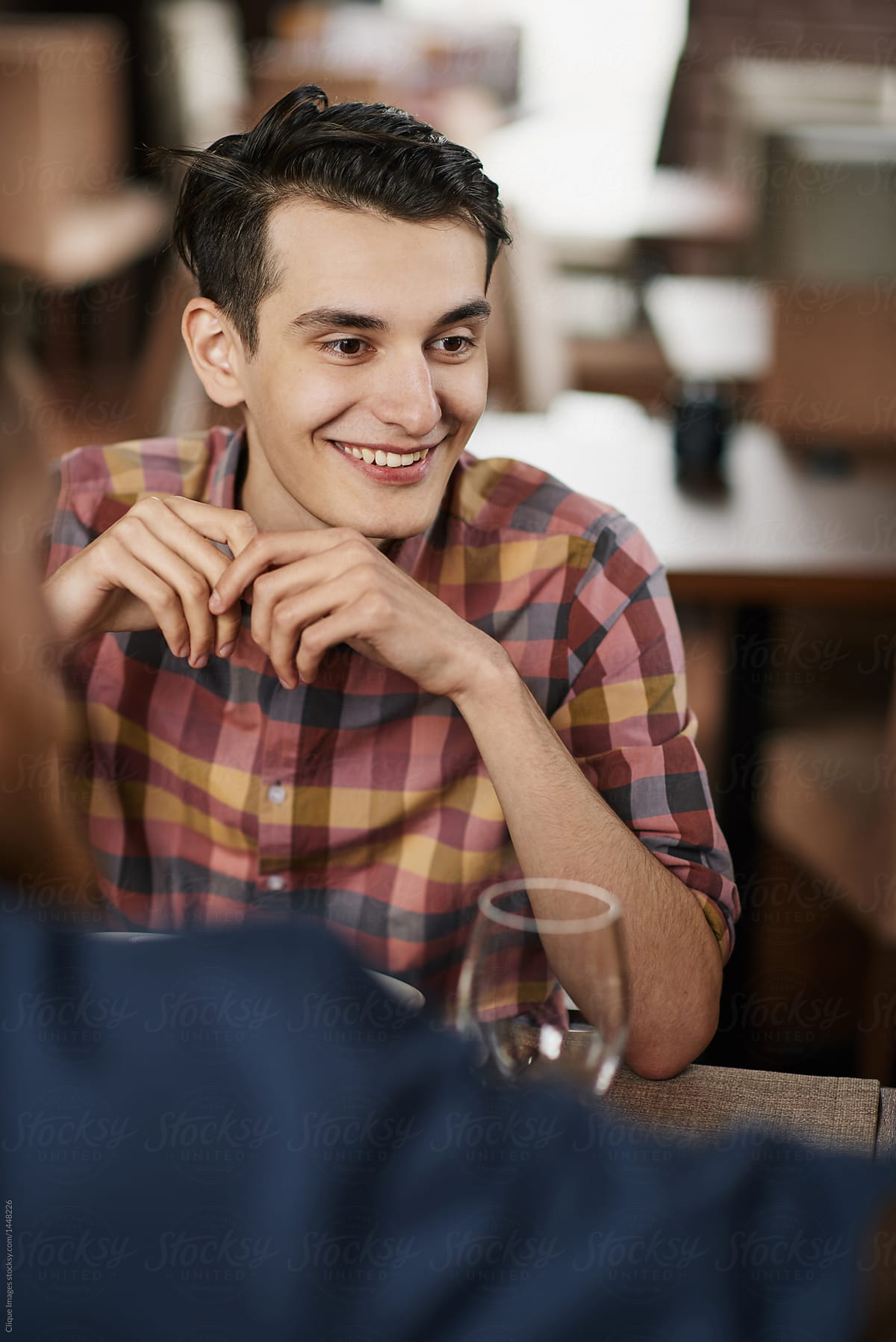 Young man dining with friends