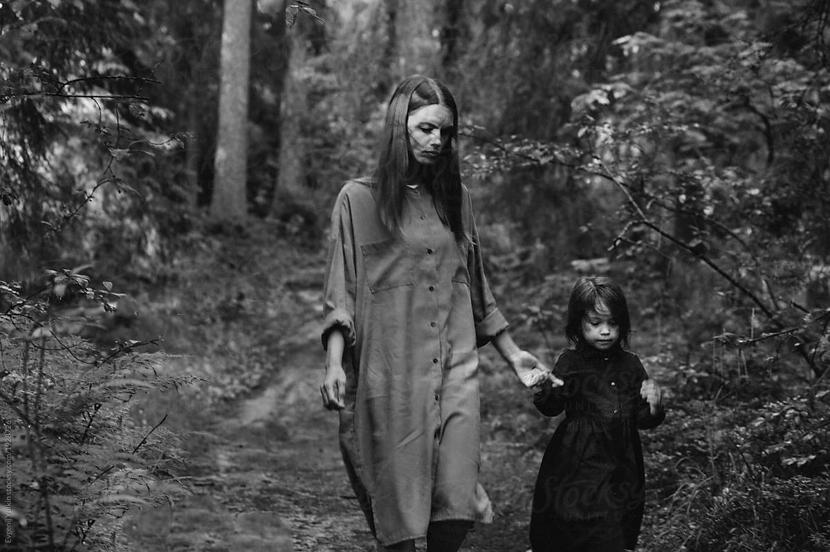 Little girl and mother in the forest