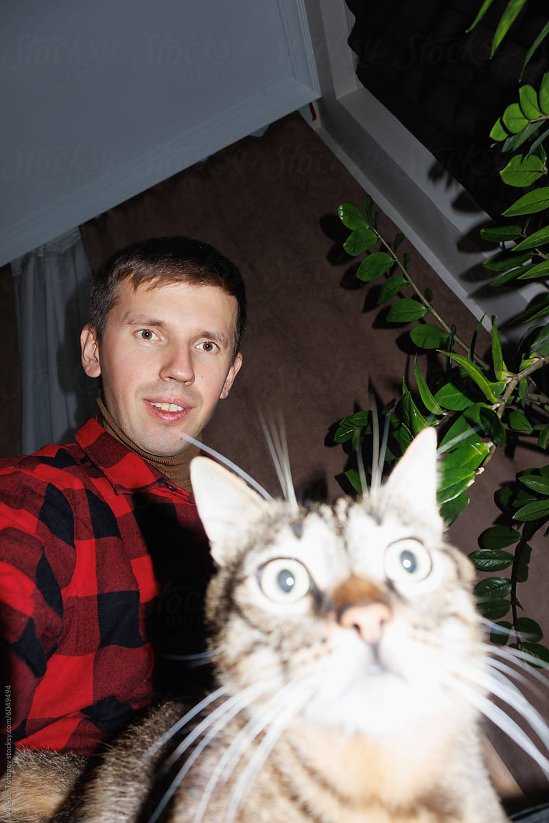 selfie of a young man with a cat