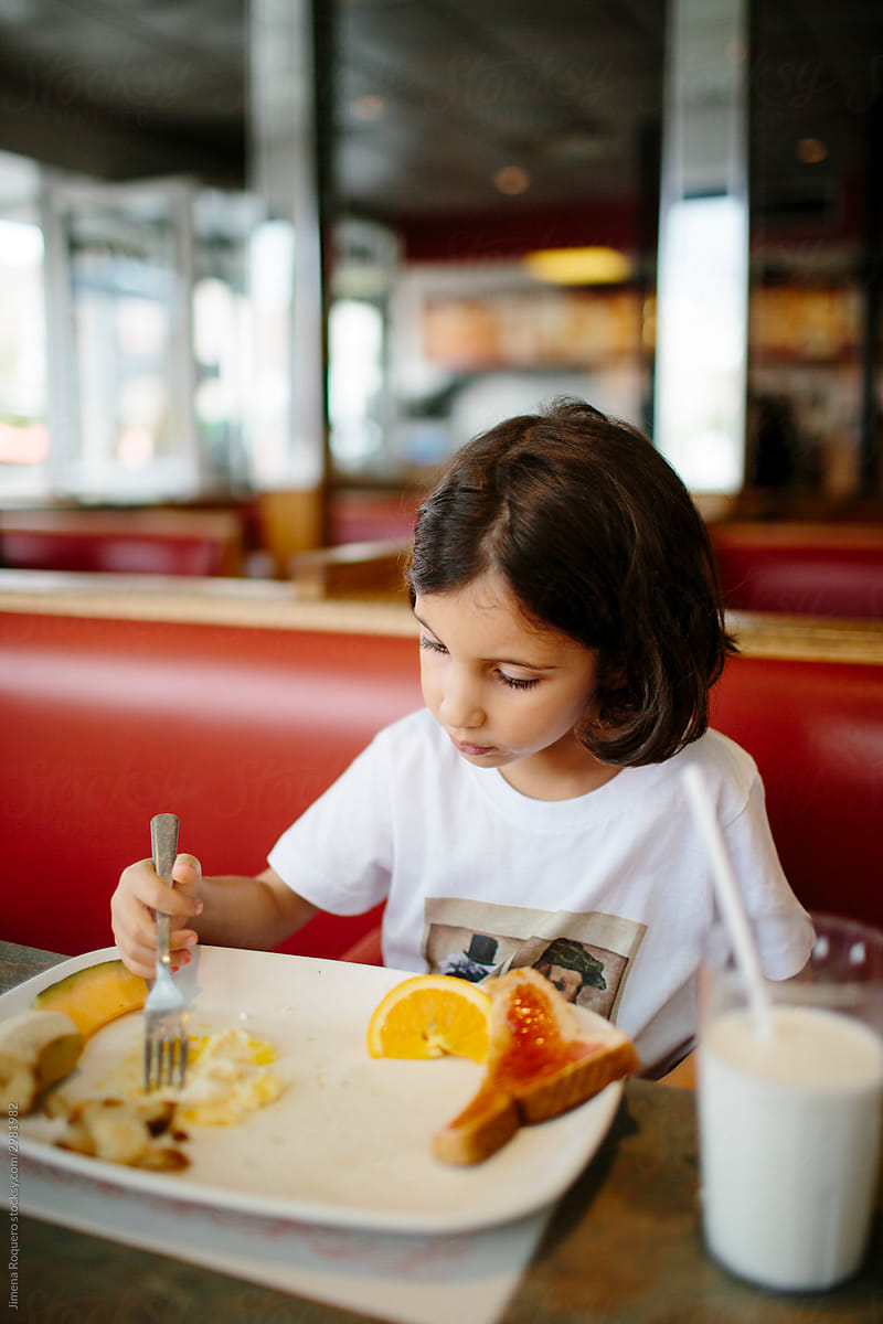 Kid eating in a diner
