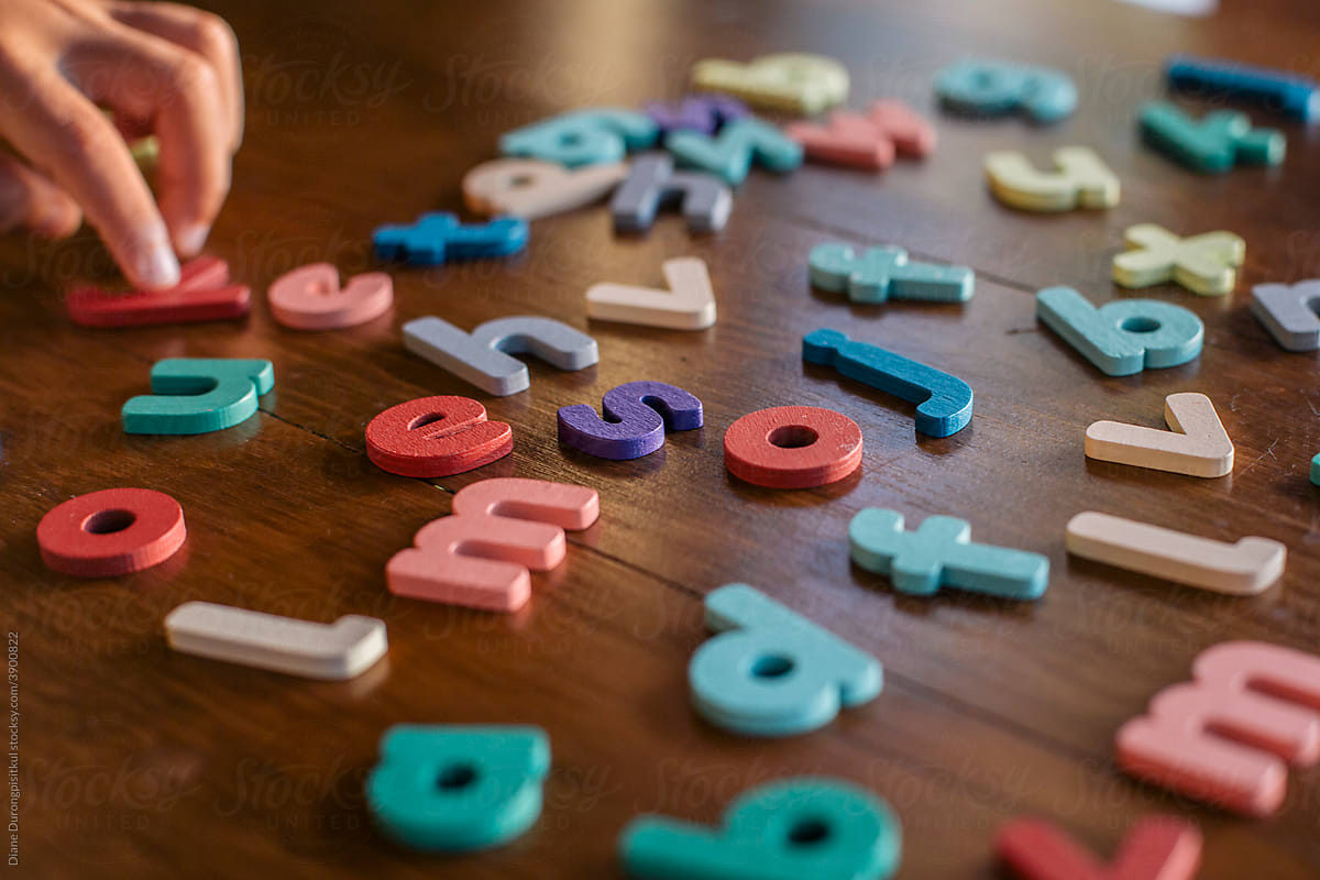 Child Selecting Wooden Letter