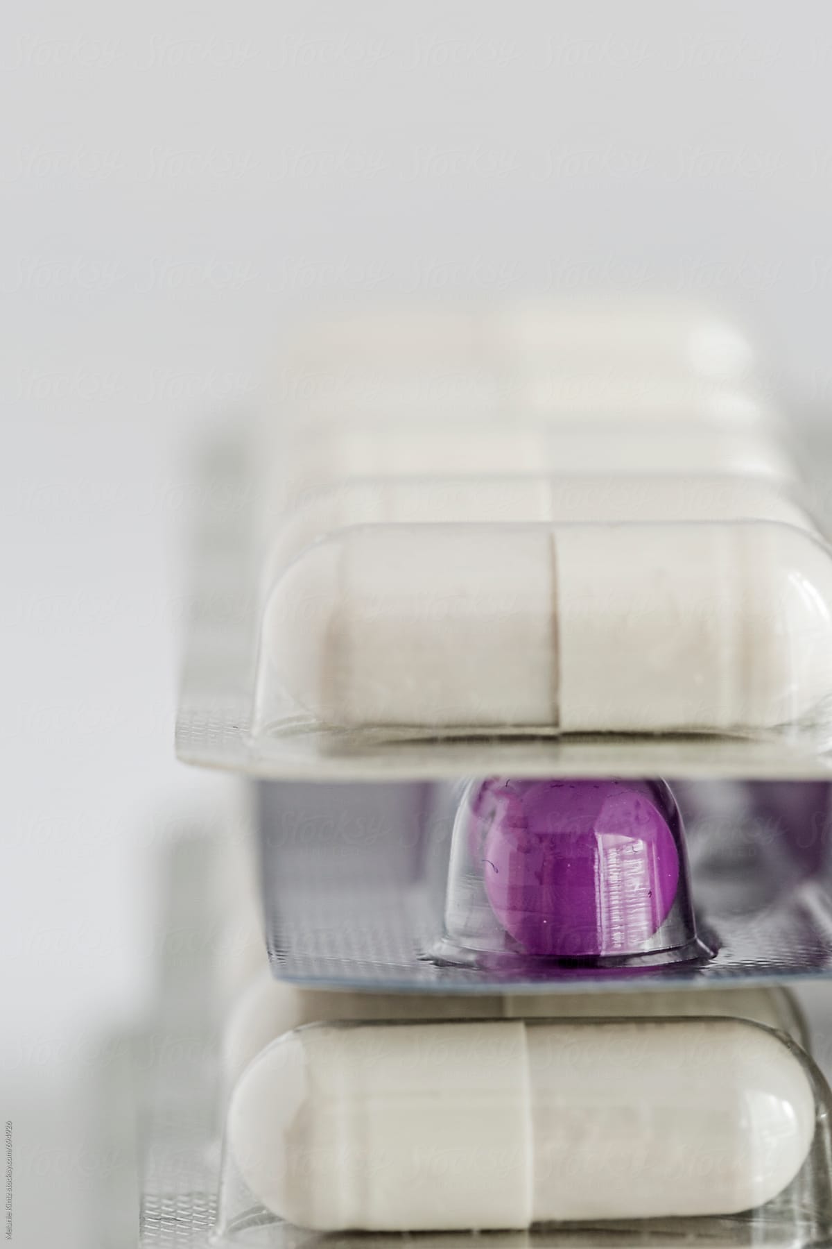 Closeup of white and purple pills in blister packs