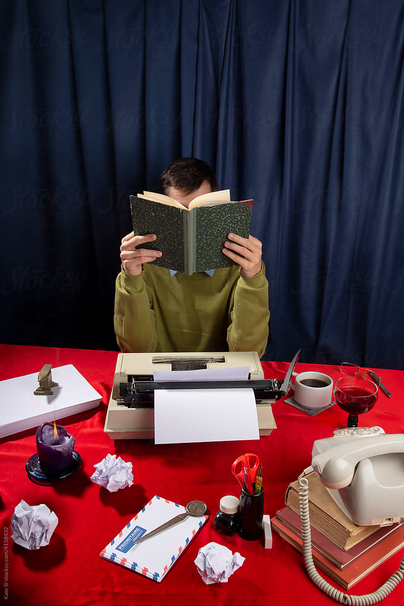 Typewriters desk / Writer behind a book
