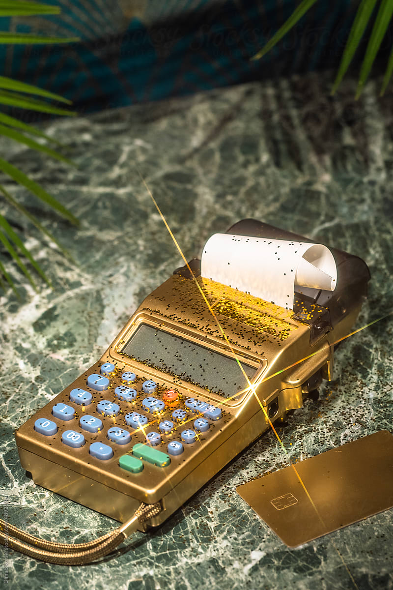 POS terminal and gold credit card with a check with a shiny glare