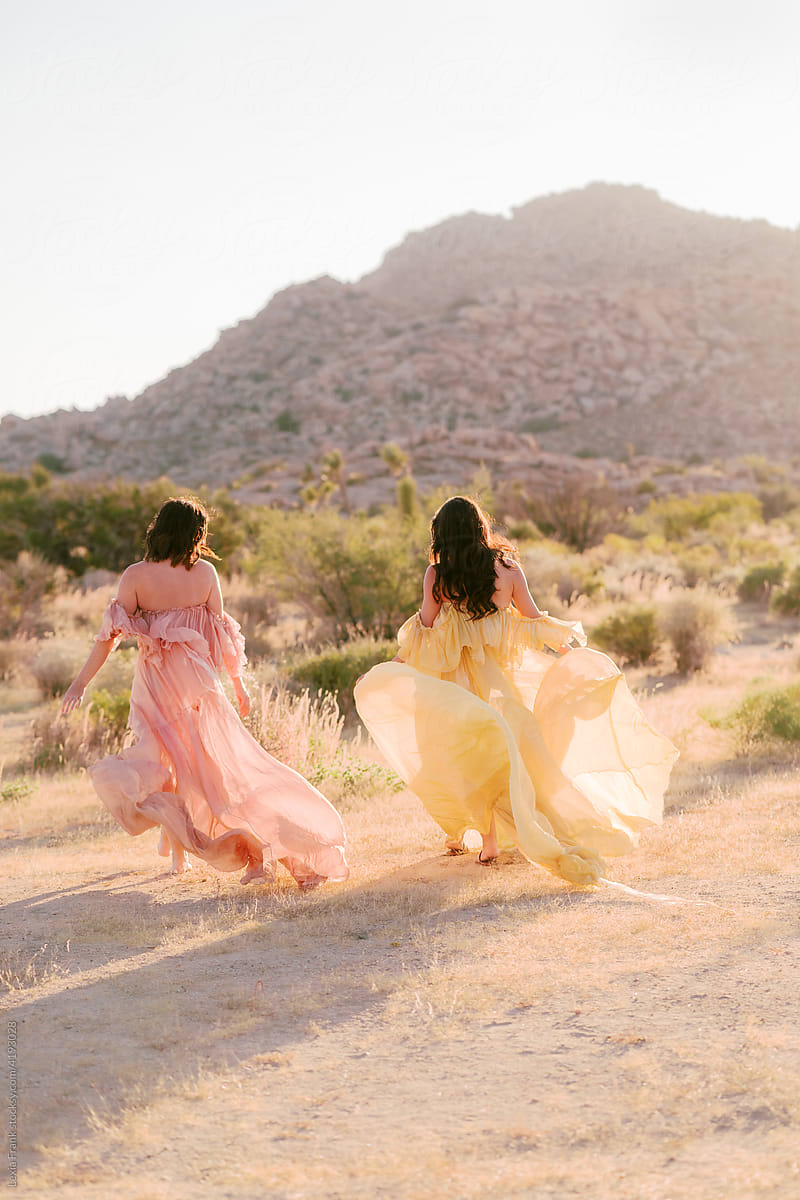 two women in the desert wearing flowy bohemian maxi dresses
