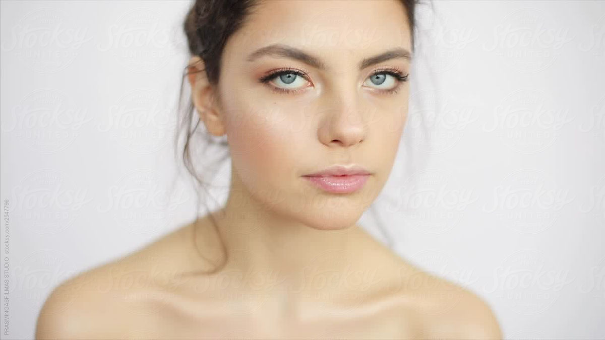Young Model With Natural Make Up Looking To Camera Close Up Indoors