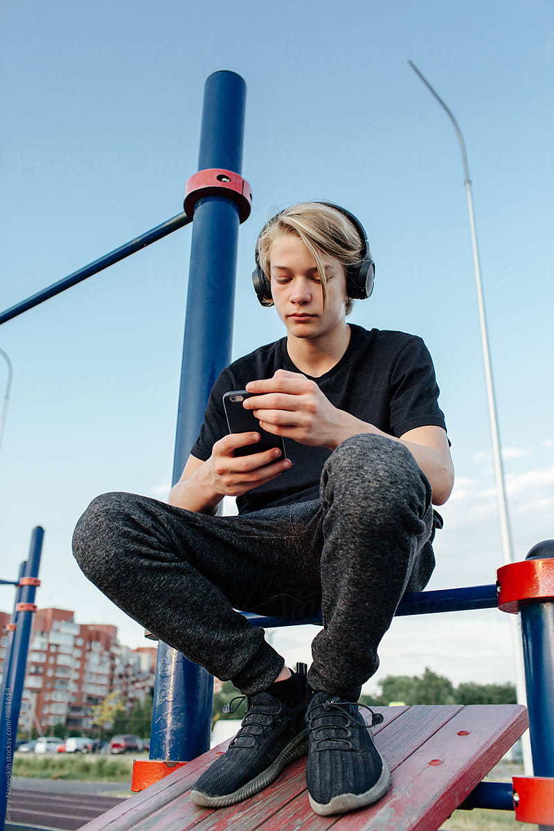 Young man in headphones on sports ground