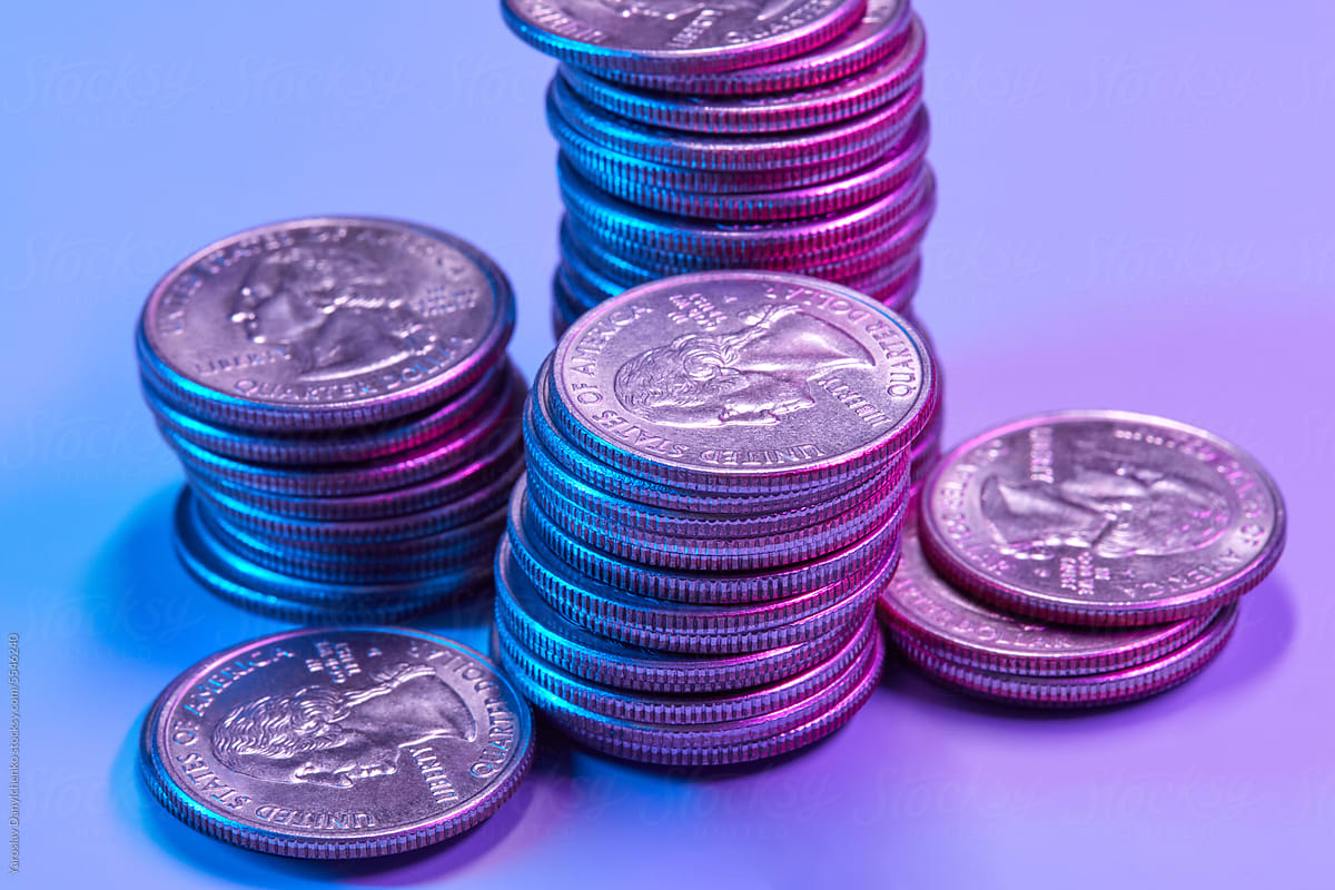 Cent coins pile against neon background.
