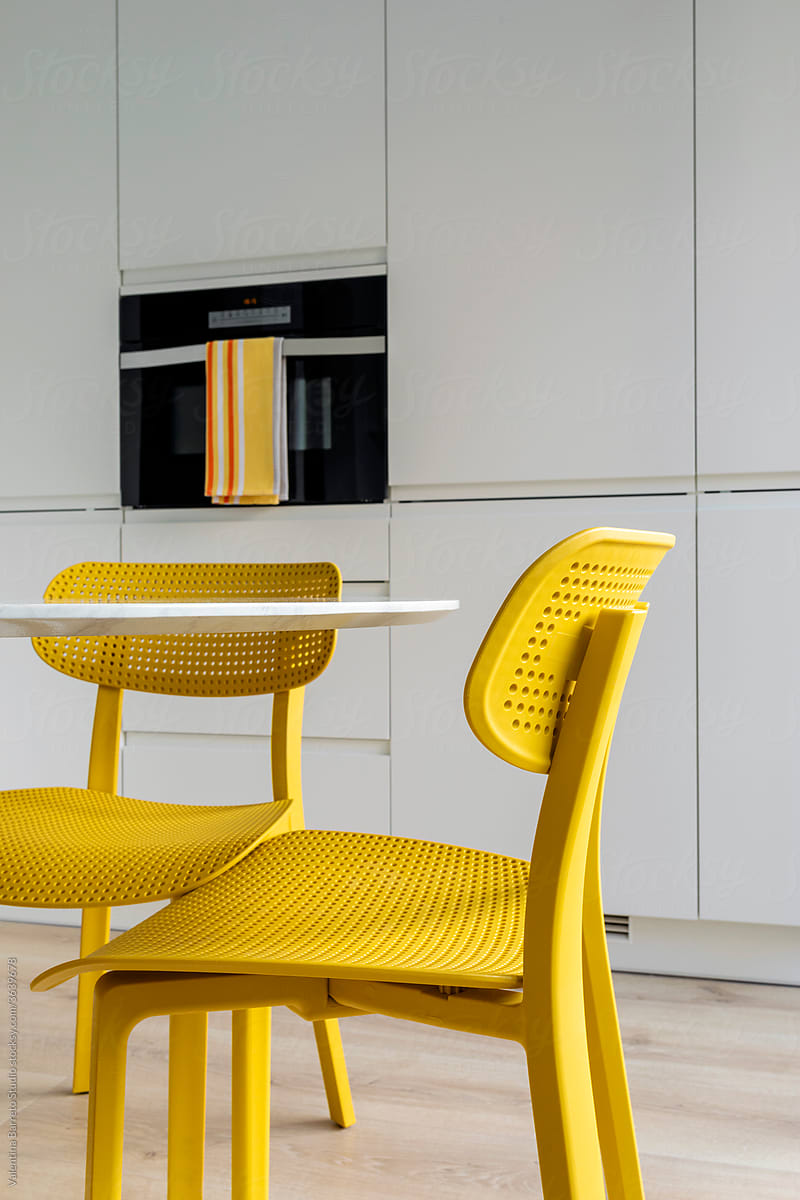Interior of stylish kitchen apartment renewal with yellow chair
