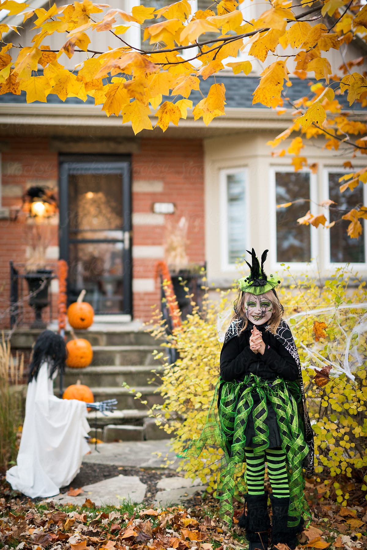 Girl Wearing Witch Costume Excited to Trick or Treat on Halloween