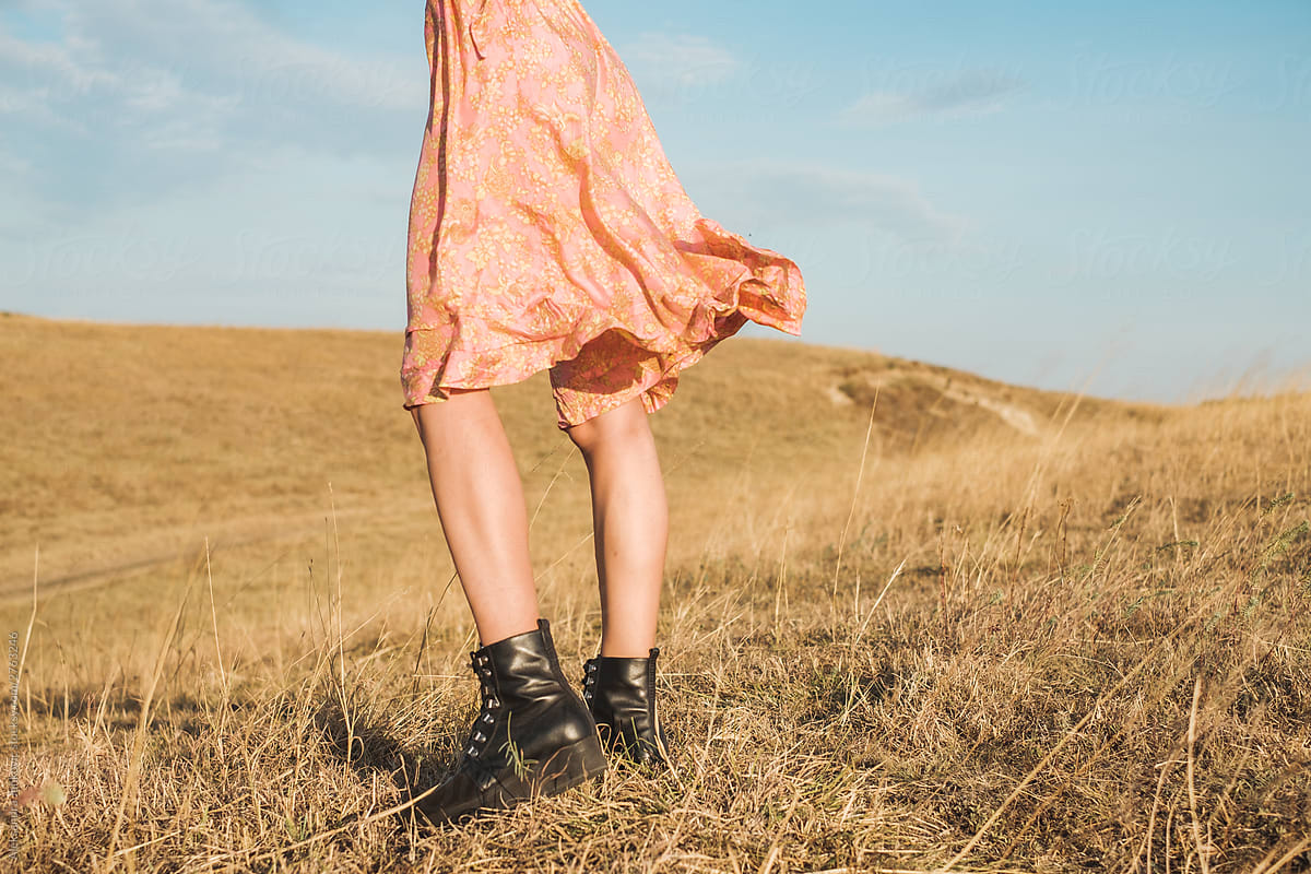 Anonymous Woman Wearing Silk Dress And Black Leather Boots In The Field