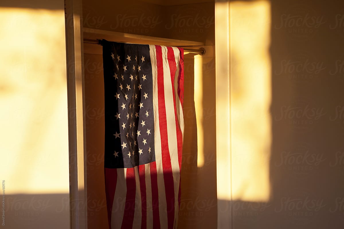 American Flag hanging in closet with setting sun light