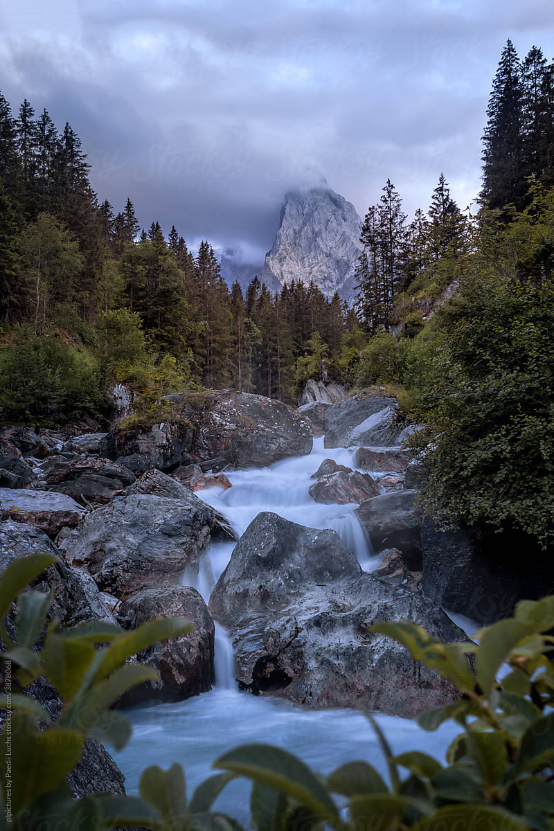 Moody morning and dreamy waterfall in the alps.