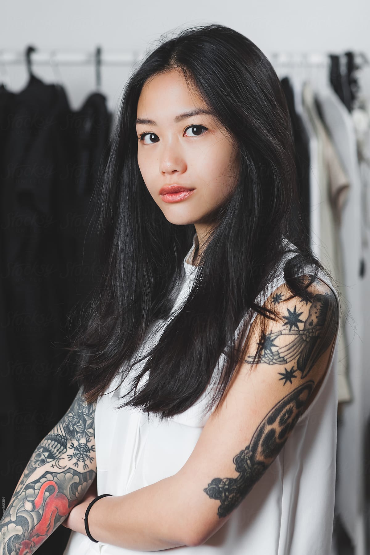 Portrait of a Young Asian Fashion Designer with many Tattoos