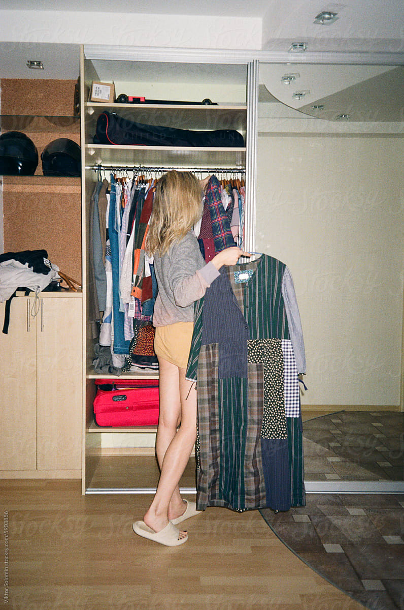 Woman in wardrobe with clothes