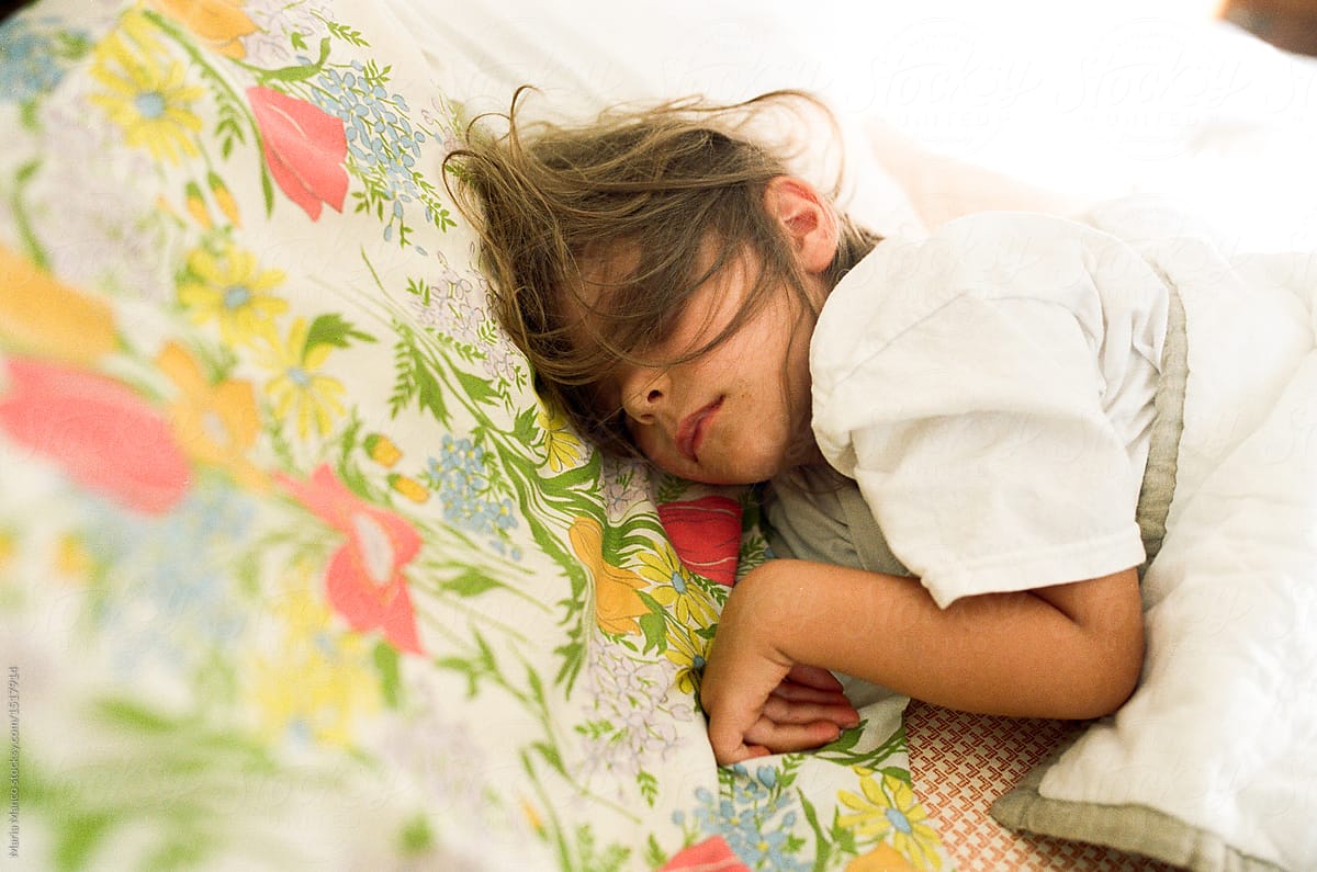 little girl sleeping on vintage sheets