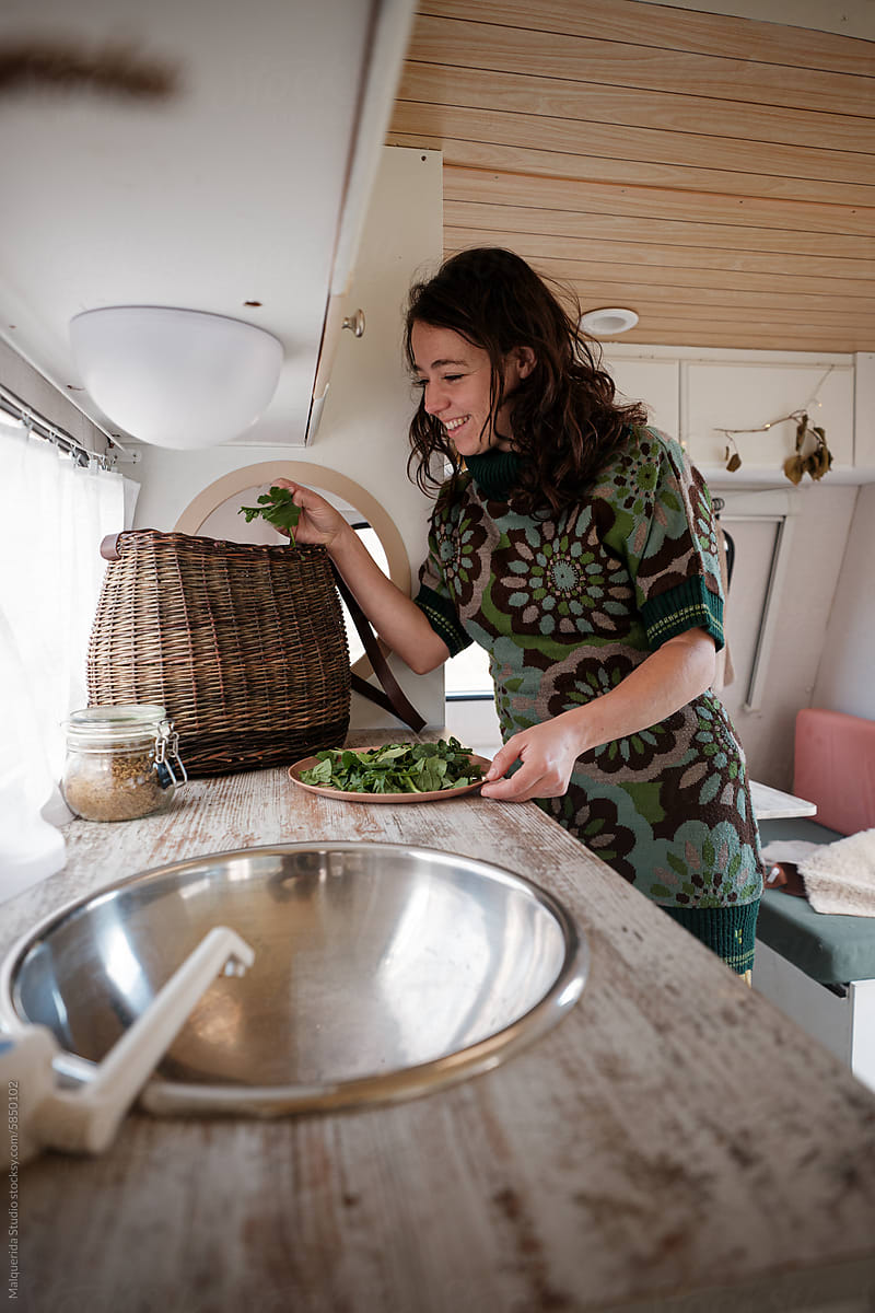 woman preparing fresh salad in a caravan