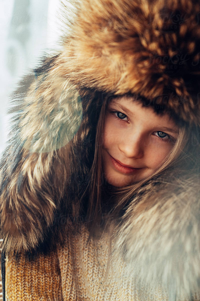 Agirl in a fur hat.