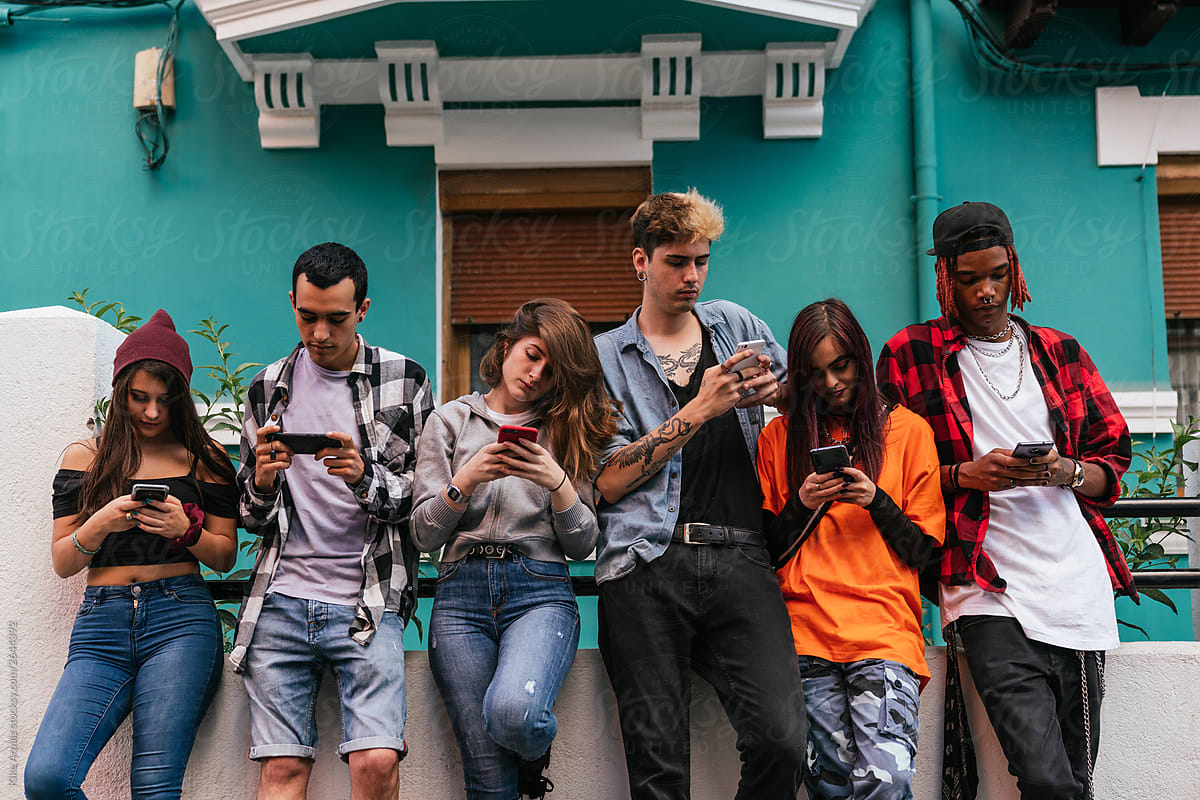 Group of multiracial friends using mobile smart phone