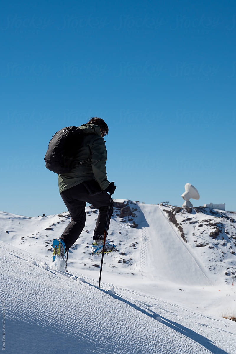 Hiker in crampons in highlands in winter