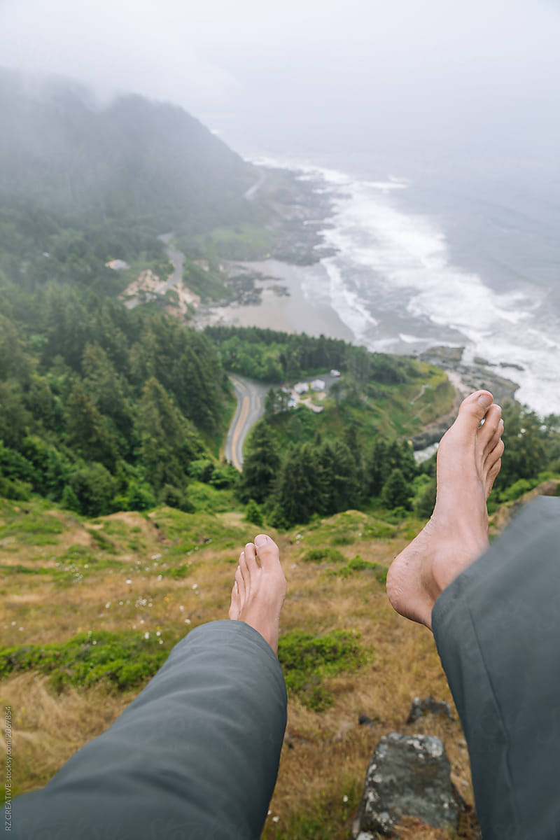Feet hanging off cliff.