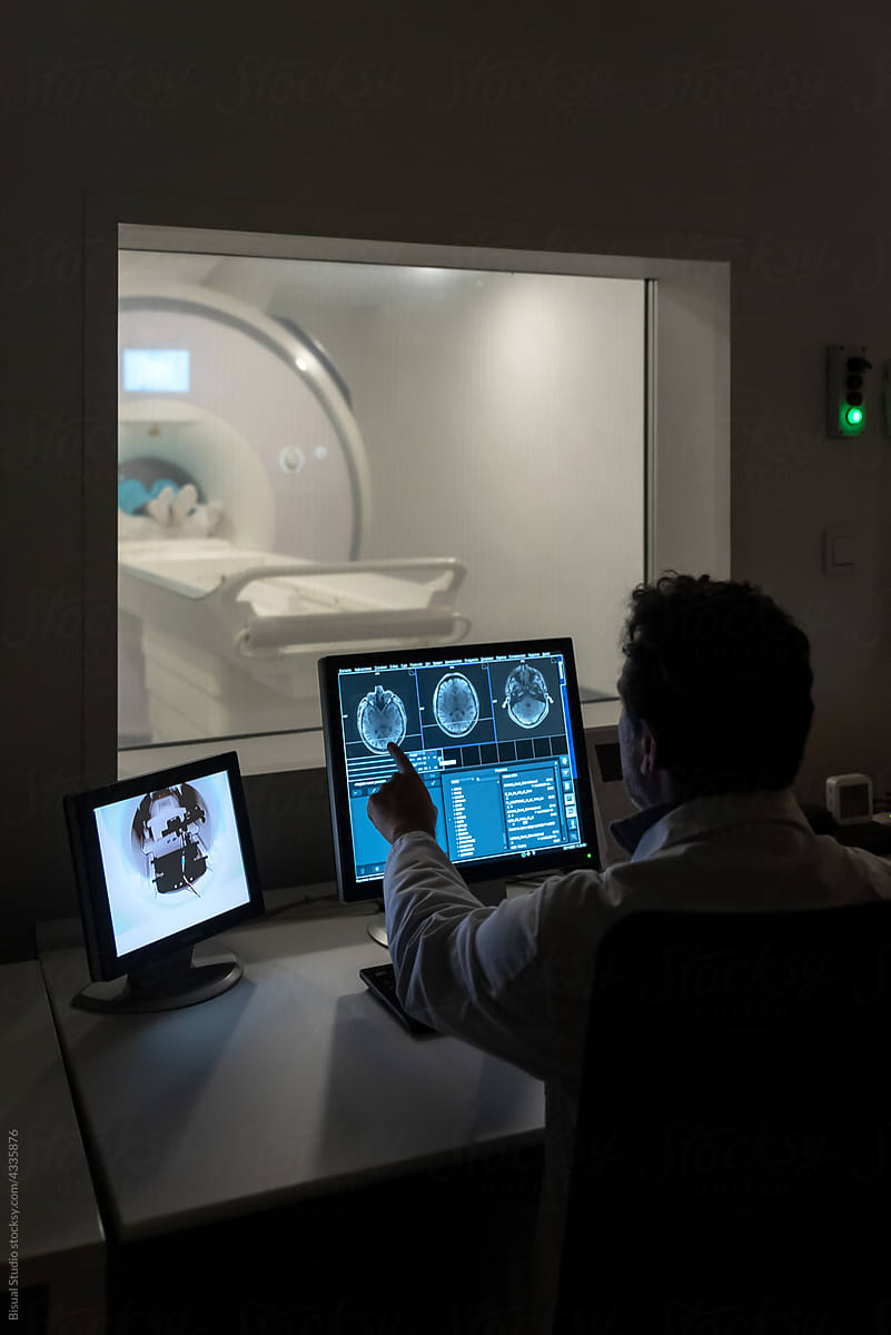 Doctor using computer during MRI procedure